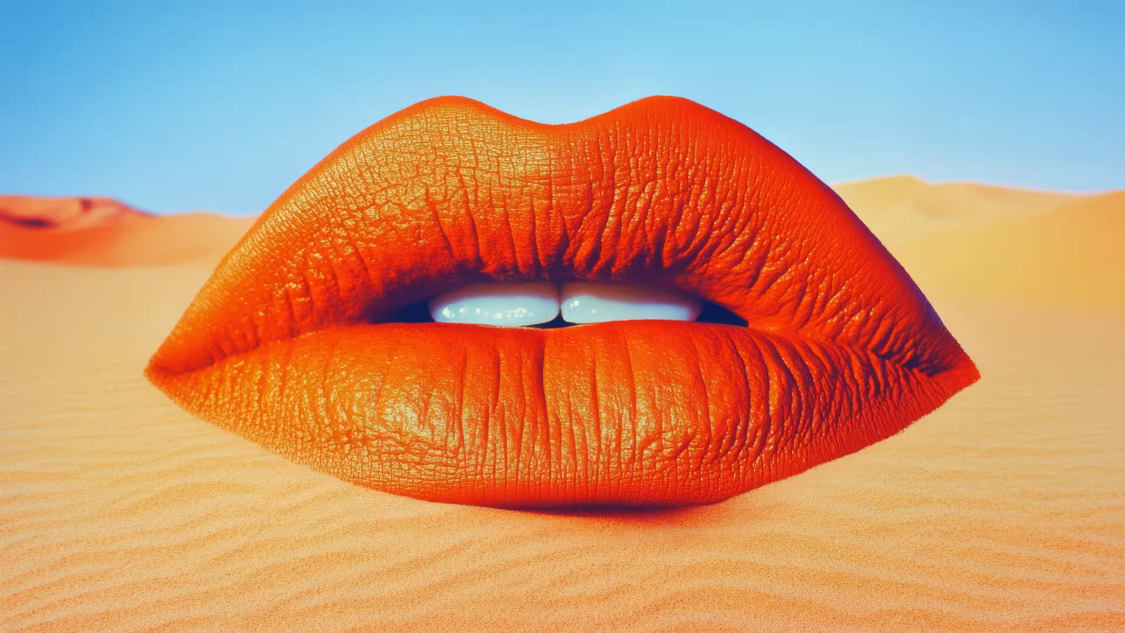 Surreal giant orange lips lying on desert sand.